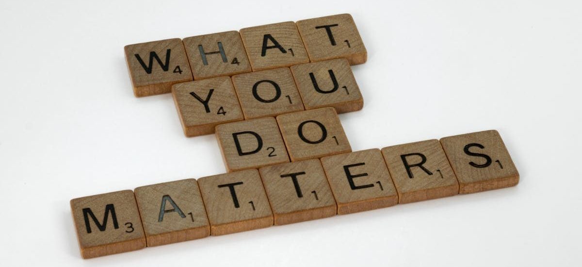 Wooden letter tiles spelling 'What You Do Matters' on a neutral background.