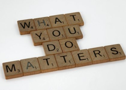 Wooden letter tiles spelling 'What You Do Matters' on a neutral background.